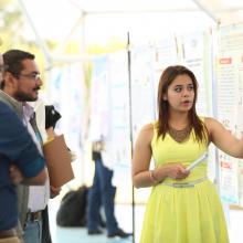 Alumna expone sus cartel ante evaluadores del EICS